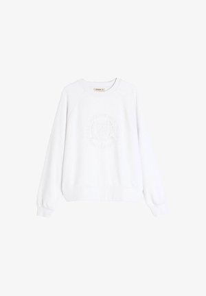 Biała bluza z ribbingowym okrągłym dekoltem, długimi rękawami raglanowymi oraz teksturowanym okrągłym logo na środku. Miękki materiał.