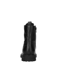 Bottine en cuir noir avec un bout arrondi, une fermeture éclair au dos et une semelle épaisse texturée. Dotée d'une languette à l'arrière pour un enfilage facile.