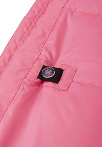Pink nylon fabric with a smooth texture, featuring a black strap and clear button detail. Sewn edges and a sleek design.