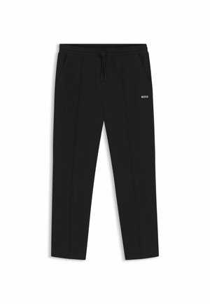 Pantalon noir fuselé avec taille à cordon, poches latérales, coutures avant et logo "BOSS" sur la cuisse droite.