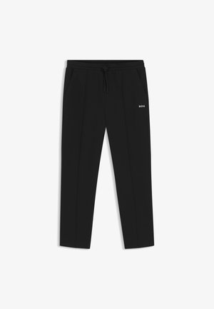 Zwarte taps toelopende broek met trekkoord in de taille, zijzakken, voornaad en "BOSS"-logo op de rechterdij.