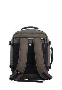 Zaino di un verde oliva scuro con spallacci imbottiti, accenti in rete, doppi scomparti con cerniera e una maniglia superiore per un facile trasporto.