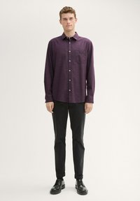 Purple checkered long-sleeve shirt with a button-down collar and single chest pocket, paired with black trousers and black shoes.