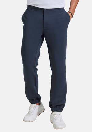 Marineblaue Jogginghosen aus einem glatten Stoff mit elastischem Bund und Bündchen; mit seitlichen Taschen und einem Knopfverschluss.