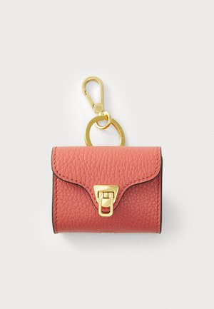 Leather pouch in coral with a gold closure and clasp. Features a textured surface, rounded corners, and a small keychain attachment.