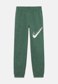 Πράσινα αθλητικά παντελόνια φτιαγμένα από υφασμάτινη υφή, με ελαστική μέση και λευκό λογότυπο Nike στη αριστερή πλευρά του μηρού.