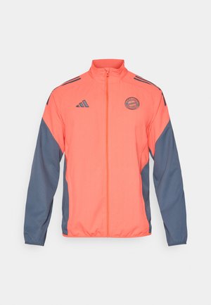 Orangene und marineblaue Zip-Jacke mit Stehkragen, Adidas-Logo und Team-Logo. Leichtes Material mit kontrastierenden Seitenpaneelen und Bündchen.