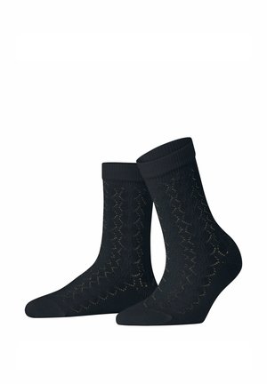 Paire de chaussettes noires montantes avec un motif tricoté fin rappelant de la dentelle et des bordures côtelées, présentées sur fond blanc.