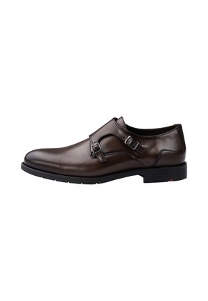 Dark brown leather men's dress shoe with double monk strap buckles and black rubber sole, shown from the side on a white background.