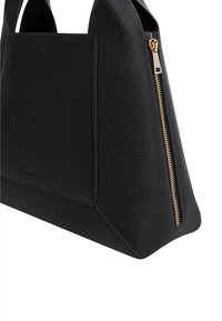 Black leather tote with a textured finish, featuring a smooth, flat front panel, gold zipper closure, and angular shape.