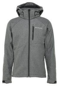 Veste Columbia grise avec une texture douce, une capuche, une fermeture éclair à l'avant et une poche poitrine zippée. Présente des accents noirs contrastants sur les poignets.