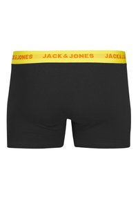 Zwarte boxershorts met een nauwsluitende pasvorm, voorzien van een gele tailleband bedrukt met "JACK & JONES" in oranje letters. Glad katoen.