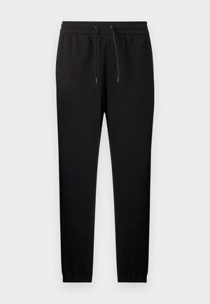 Pantalon de survêtement noir fuselé avec taille élastique et cordon de serrage, doté de chevilles resserrées et de poches latérales.