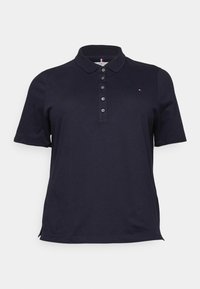 Marinblå polo-shirt i bomull, med krage, korta ärmar och fem knappar; liten logotyp på vänster bröst.