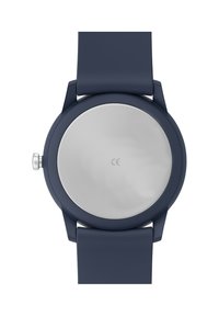 Montre ronde avec un dos en acier inoxydable argenté lisse et un bracelet en silicone bleu marine. Design simple avec une couronne sur le côté pour les réglages.