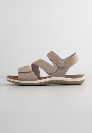 Sandali beige con tre cinghie regolabili, realizzati in tessuto testurizzato, caratterizzati da una suola leggera con motivi circolari per una buona aderenza.