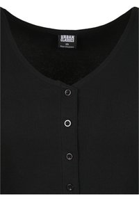 Mustavartalo-toppi syvällä V-kaula-aukolla, jossa on neljä nappia edessä ja "URBAN CLASSICS" -labeli kaula-aukossa. Valmistettu pehmeästä kankaasta.
