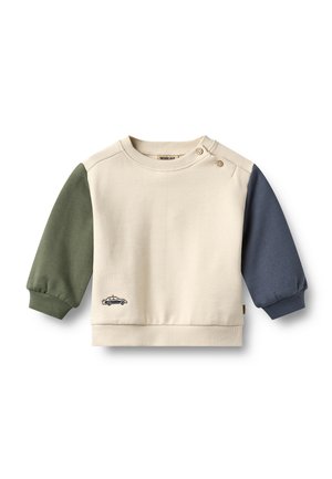 Sweat-shirt pour tout-petit couleur crème avec manche gauche verte, manche droite bleue, deux boutons aux épaules et une petite broderie de voiture sur le devant.