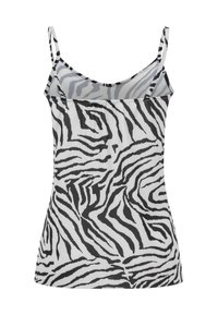 Haut sans manches pour femme avec fines bretelles présentant un motif à rayures zèbre noir et blanc sur un tissu texturé.