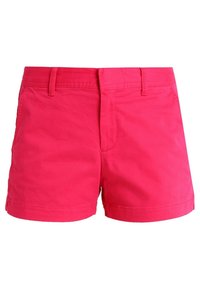 Svetle růžové kraťasy vyrobené z lehkého materiálu. Mají přiléhavý střih, plochý přední díl a standardní pas s poutky na opasek. Žádné viditelné kapsy.