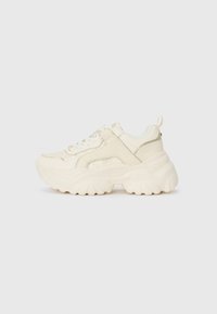 Chunky sneakers in off-white leather with textured paneling, thick rubber sole, and lace-up front. Features a pull tab at the heel.