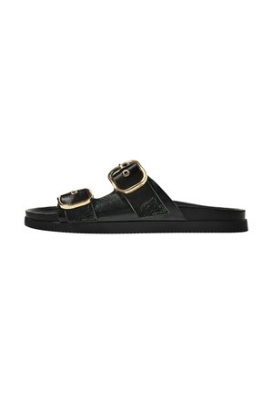 Black slide sandal with two gold buckle accents, smooth textured material, flat sole, and a minimalist design.