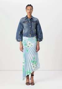 Denim jacket with a fitted design and bell sleeves, paired with a light blue pleated skirt featuring floral patterns in green and white.
