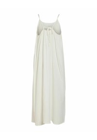 Robe maxi blanche sans manches avec bretelles fines et un détail noué dans le dos ouvert, en tissu léger.