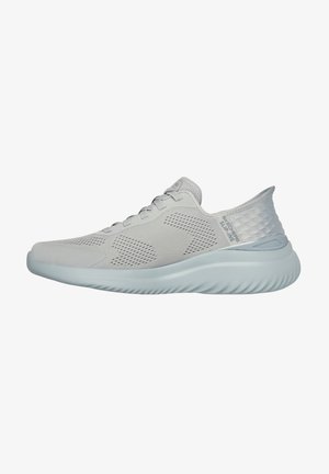 Light gray athletic shoe with a textured mesh upper, cushioned sole, and a molded heel. Features lace-up closure and subtle branding.