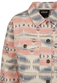 Button-up jacket featuring a pink, blue, and cream geometric pattern. Made of textured fabric with two front pockets and metal buttons.