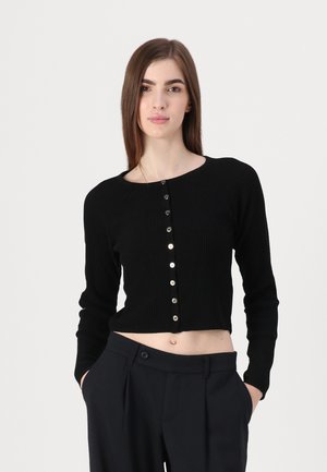 Black ribbed cropped cardigan with long sleeves, featuring a rounded neckline and metallic buttons down the front. Smooth knit texture.