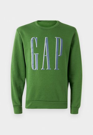 Sweatshirt vert à col ras du cou avec un grand logo "GAP" blanc et bleu sur le devant. Tissu doux avec des poignets et un ourlet côtelés.