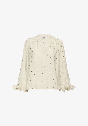 Crème blouse met zwarte stippen, lange mouwen met gerimpelde manchetten en een V-hals. Gemaakt van lichtgewicht stof.
