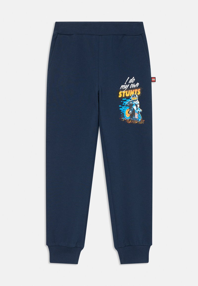 Navy blue joggers made of cotton with elastic waistband and cuffs. Features a colorful graphic of a LEGO figure riding a motorcycle.