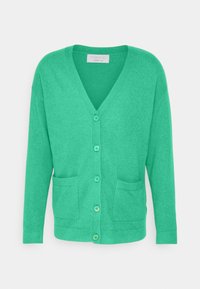 Grüner V-Ausschnitt Kaschmir-Cardigan mit langen Ärmeln, Knöpfen vorne und zwei aufgesetzten Taschen vorne, vor einfarbigem Hintergrund dargestellt.