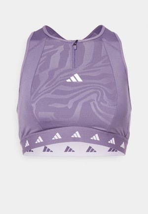 Purple sports bra with a zip front, featuring a subtle tiger stripe pattern and a geometric triangle design at the hem.