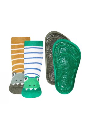 Kindersocken-Set mit zwei Designs: eines mit orangefarbenen Streifen und einem Dinosaurier-Motiv, das andere mit grün-blauen Streifen und einem Krokodilsgesicht.