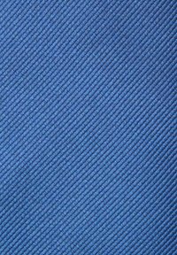 Rakenteellinen sininen kangas, jossa on diagonaalinen uritus, keskipaksu kudonta ja kirkas, tasainen väri koko pinta-alalla.