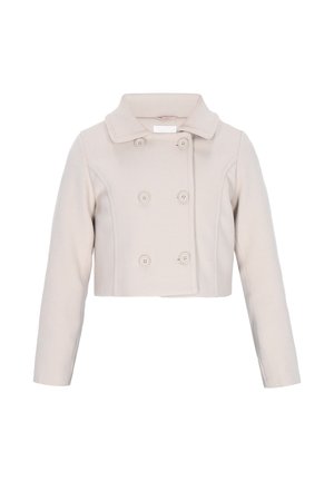 Lühendatud beež mantel, millel on nokaga krae, topeltrinnaga esikülg ja kuus ümmargust nööpi. Valmistatud pehmest, tekstuuriga kangast pikkae toevarrega.