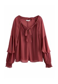 Blouse rouge rouille à manches longues avec encolure froncée, nouée sur le devant, manches évasées à étages et poignets élastiqués, en tissu léger et transparent.