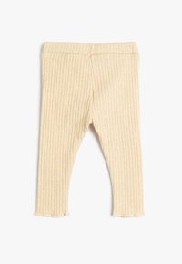 Leggings para bebé de punto acanalado beige con cinturilla elástica y ligero dobladillo rizado sobre fondo blanco.