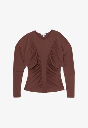Hosszú ujjú felső gazdag barna színben, elöl gyűrt részletekkel, kerek nyakkivágással és testhezálló sziluettel. Puha anyagból készült.