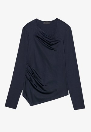 Jūras spēku zils garajām piedurknēm tops ar iztīdītu priekšpusi un sānu krunkām. Ar V veida kakla izgriezumu un asimetrisku apakšmalu. Gluda, elastīga auduma.