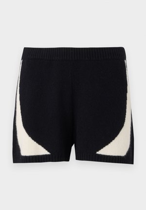 Strickshorts in Schwarz mit kontrastierenden cremefarbenen geometrischen Mustern an den Seiten. Sie verfügen über einen gerippten Bund und eine weiche Textur.