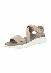 Beige sandal with a suede upper, featuring two wide straps and a rear heel strap. The sole is white, with a textured surface for grip.