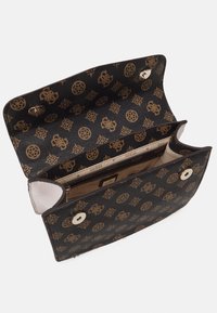 Black textured handbag with gold logos, featuring a snap closure and a beige interior. The interior has compartments for organization.