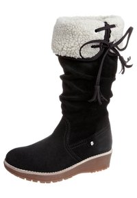 Botte en daim noir avec un bord en fourrure blanche, tige froncée et semelle compensée. Elle présente un détail lacé et un embout arrondi.