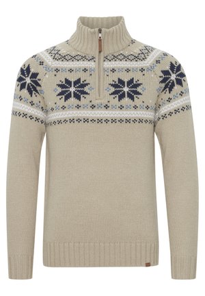 Pull en maille beige avec un col zippé mi-hauteur, présentant un motif de flocon de neige en bleu marine et bleu sur la poitrine, ainsi qu'un ourlet et des poignets côtelés.