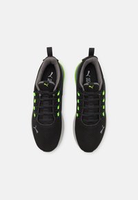 Black mesh athletic shoes with neon green accents and laces. Features gray lining and textured soles. Logo on the sides and tongue.