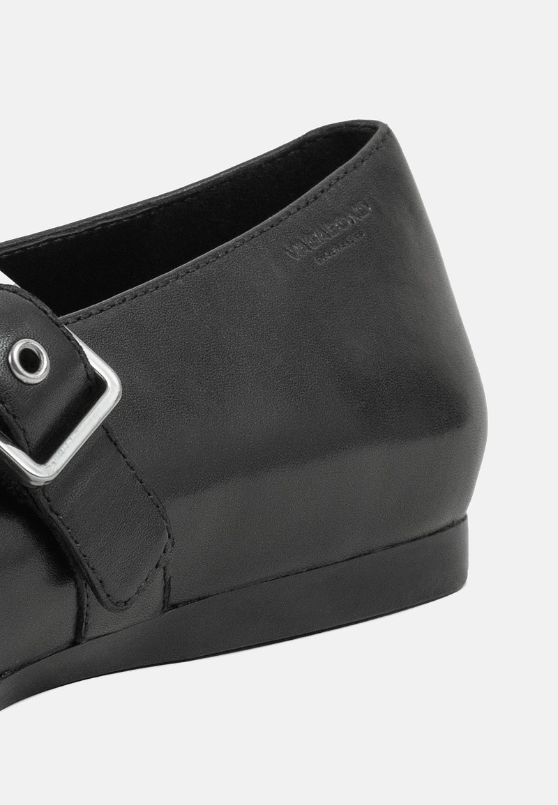 Schwarzer Lederschuh mit runder Spitze, ausgestattet mit einer seitlichen Schnalle und glatter Textur. Die Gummisohle sorgt für Stabilität.